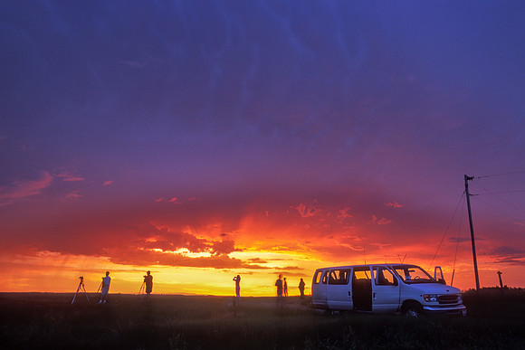 Storm Chasing Vacationeers Photographing Storm at Sunset