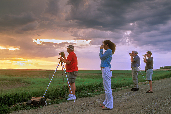 Storm Chasing Vacationeers Photographing Storm at Sunset