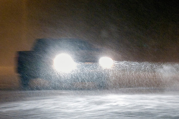 Pickup Truck Driving in Heavy Snow at Night