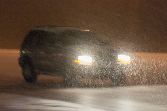 SUV Driving in Snow Storm at Night