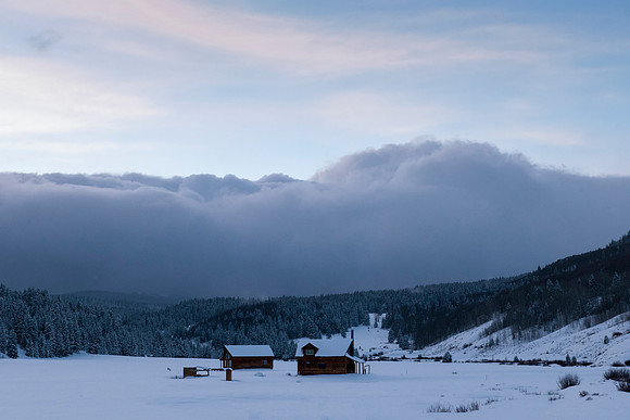Winter Storm Approaching Log Cabins