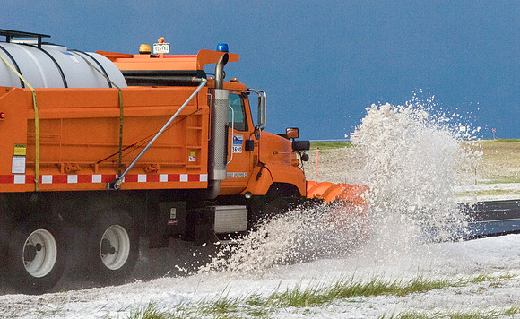 Snowplow Removing Hailstones from Highway