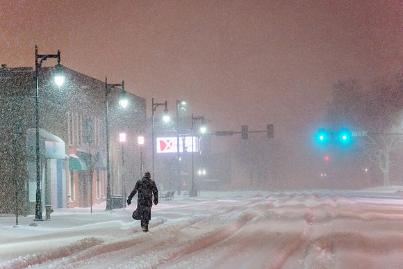 Lone Man Walking in Snow Storm at Night