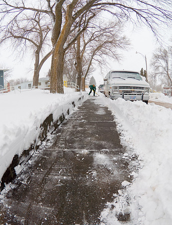 Person Shoveling Snow in Rural Neighborhood