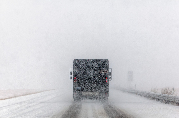 Delivery Truck Driving on Interstate During Blizzard