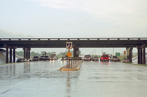 Motorists Parked Underneath Overpass During Storm