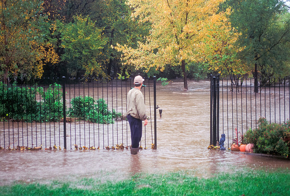 Man Observing Flash Flooding in Residential Neighborhood